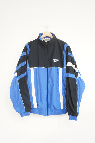 Vintage 90's Reebok blue and black tracksuit jacket with embroidered logo on the chest