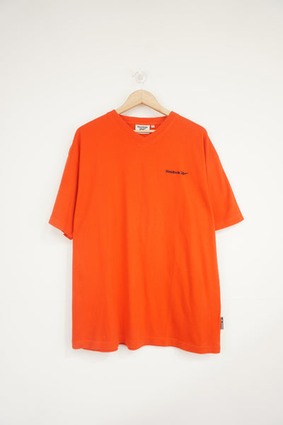 Vintage orangey red Reebok v-neck t-shirt with embroidered logo on the chest