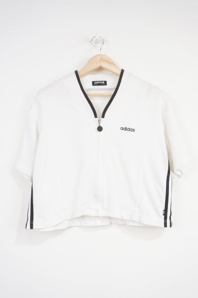 White Adidas zip through crop top with embroidered logo on the front and three stripe details down the side