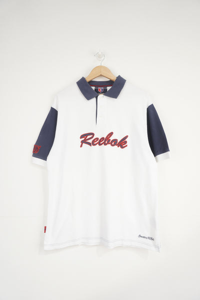 Reebok white and navy polo shirt with embroidered logo across the chest