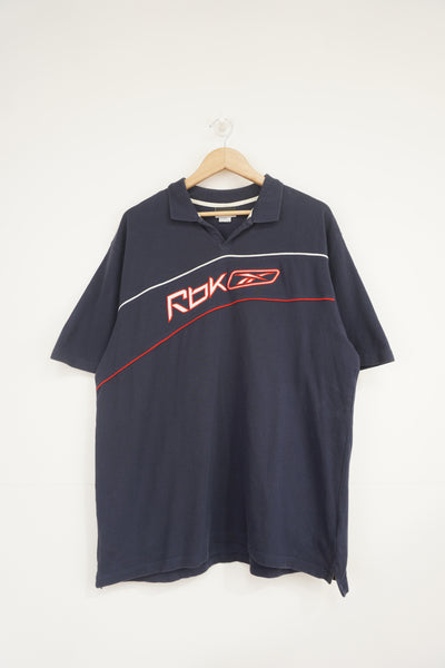 Reebok navy polo shirt with embroidered logo across the chest