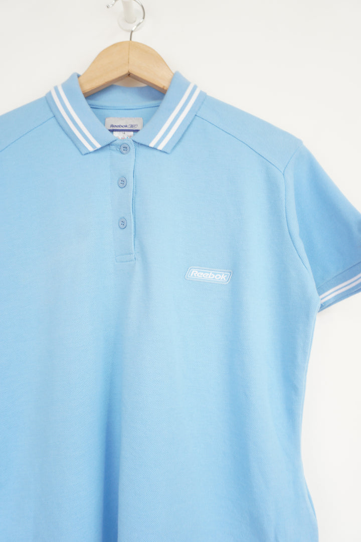 Baby blue Reebok polo shirt with embroidered logo on the chest