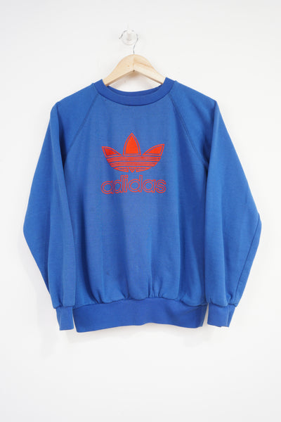 Vintage 80s Adidas blue crewneck sweatshirt with embroidered spell-out logo on the chest 