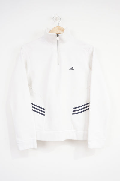 Adidas white 1/4 zip sweatshirt with navy blue embroidered logo on the chest and three stripes on the side 