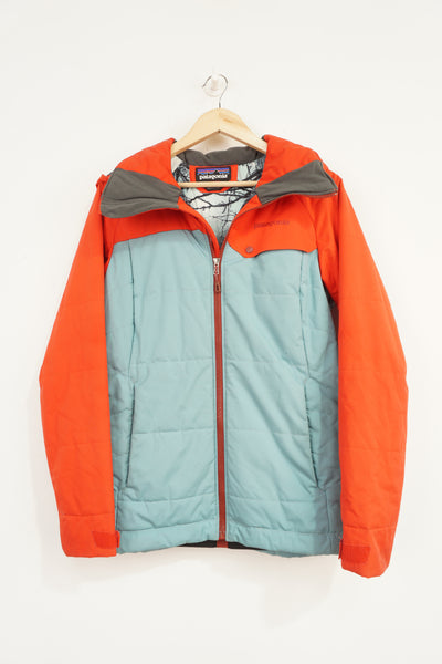 Patagonia lightly padded red and blue ski style jacket with signature logo on the chest and zip up pockets 