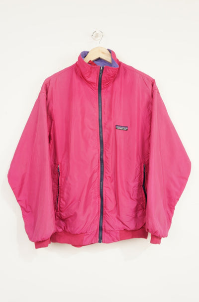 Vintage 1990's pink Patagonia zip through jacket with purple fleece lining and embroidered logo on the chest
