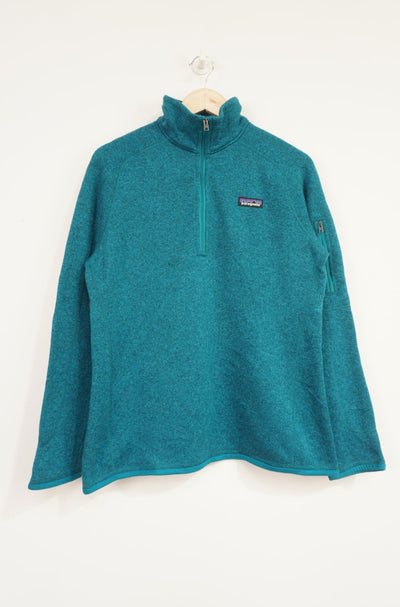 Patagonia bright blue knit style 1/4 zip fleece with zip up sleeve pocket and embroidered logo on the chest