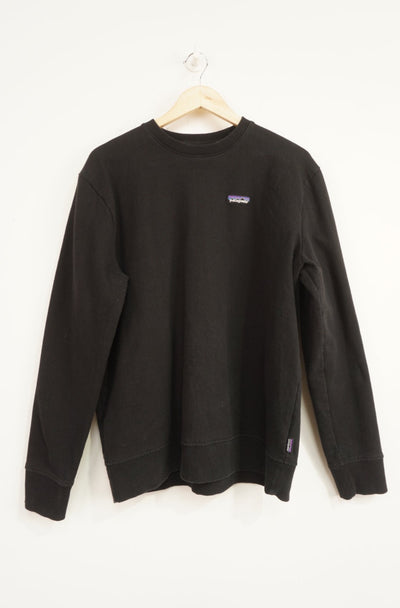 Patagonia black crew neck sweatshirt with embroidered spell-out logo on the chest