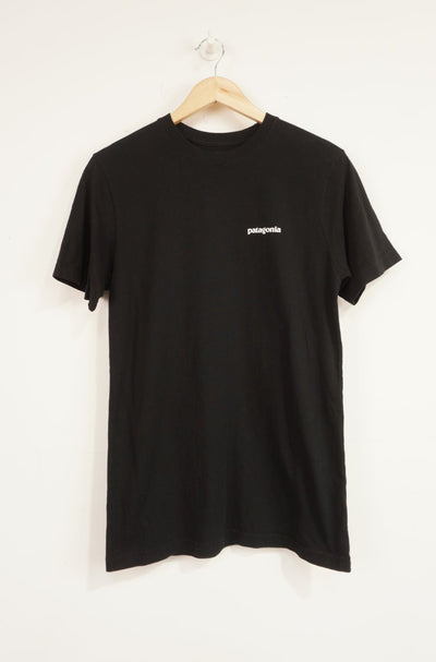 Patagonia black responsibili-tee with printed spell-out logo on the front and signature mountain graphic on the back 