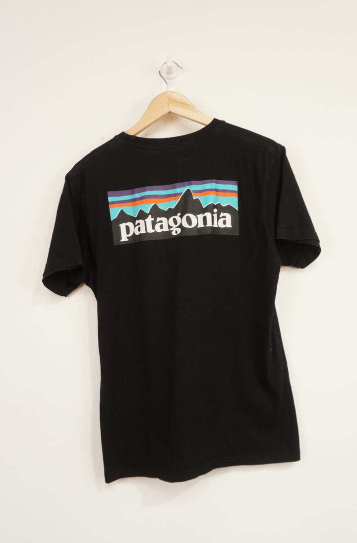 Patagonia black responsibili-tee with printed spell-out logo on the front and signature mountain graphic on the back 