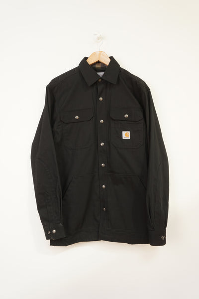 Black light weight cotton Carhartt chore jacket with plaid lining and multiple pockets