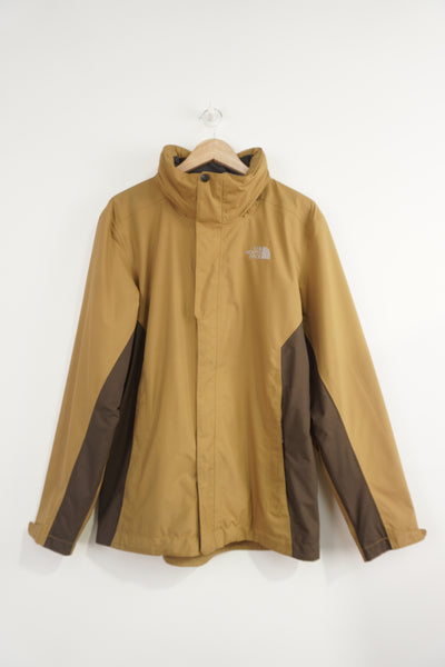 The North Face zip through windbreaker jacket with embroidered logo, multiple pockets and foldaway hood
