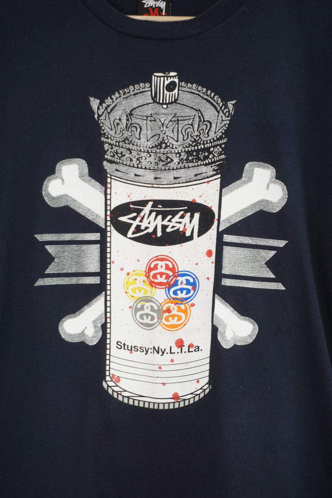 Vintage Stussy navy blue t-shirt, with spray paint can graphic on the front 
