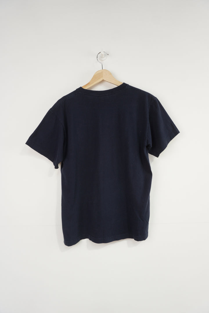 Vintage Stussy navy blue t-shirt, with spray paint can graphic on the front 