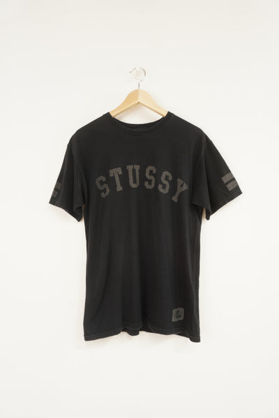 Vintage Stussy black t-shirt, with spell-out graphic on the front and back