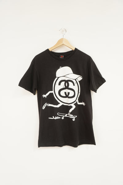 Vintage Stussy black t-shirt, with skateboarding graphic on the front