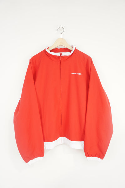 All red Reebok zip through track jacket with embroidered logo on the chest
