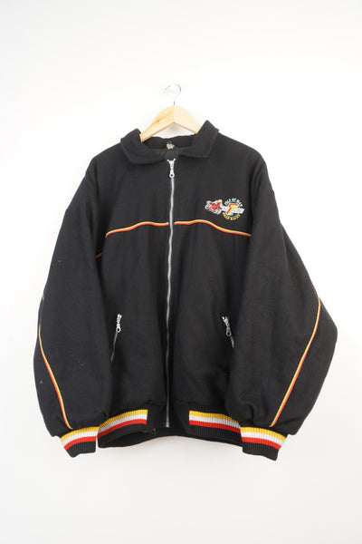 Vintage black TT wool bomber jacket with embroidered isle of man 2000 road races logo on the chest and T 2000 on back. Closes with a zip.