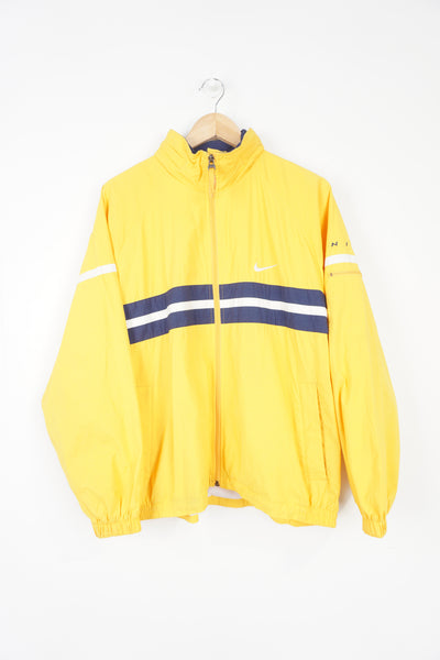 00's yellow Nike zip through shell jacket with embroidered logo on the chest and foldaway hood