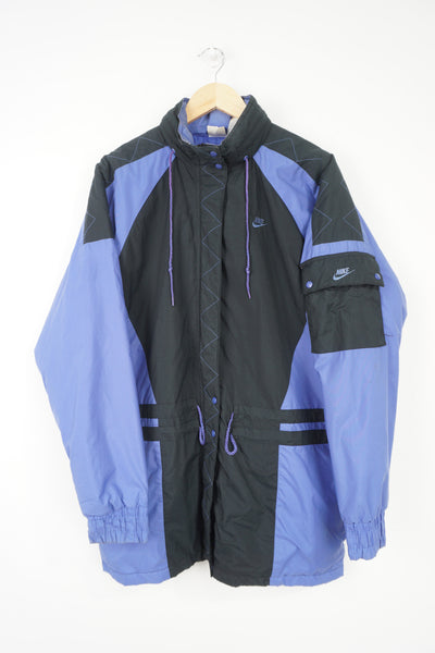 Vintage Nike purple and black zip through sports coat, with embroidered swoosh logos on the front, sleeve and fold away hood