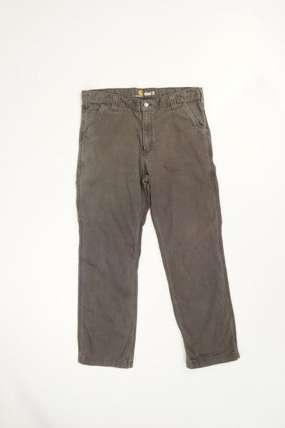 Stone grey Carhartt relaxed fit straight leg jeans with signature logo on the back pocket