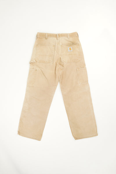Tan Carhartt double knee carpenter style jeans with multiple pockets