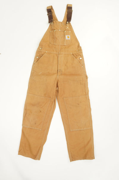 Tan Carhartt carpenter style full length dungarees with double knee patches and embroidered logo on the pocket