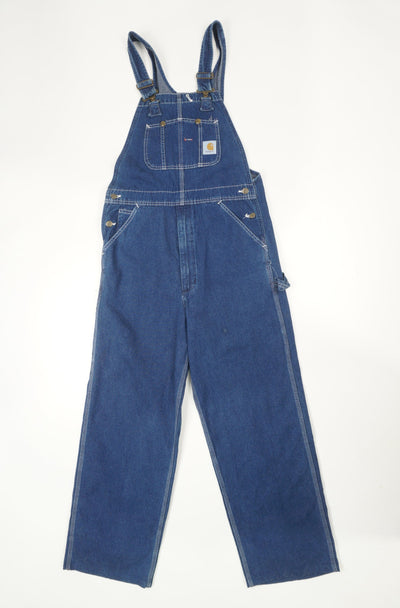 Carhartt blue denim carpenter style full length dungarees with multiple pockets and embroidered logo on the pocket