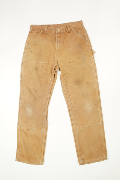 Tan Carhartt double knee carpenter style jeans with multiple pockets
