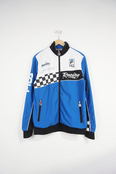 Vintage blue and black Fila Italia Motor Racing jacket features printed logos on the front and checker flag cuffs