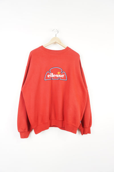All red Ellesse sweatshirt, with embroidered spell-out logo across chest  good condition - some slight bobbling near the hem  Size in Label:  M - Measures like mens XL  Our Measurements:  Chest: 27 inches Length: 26 inches