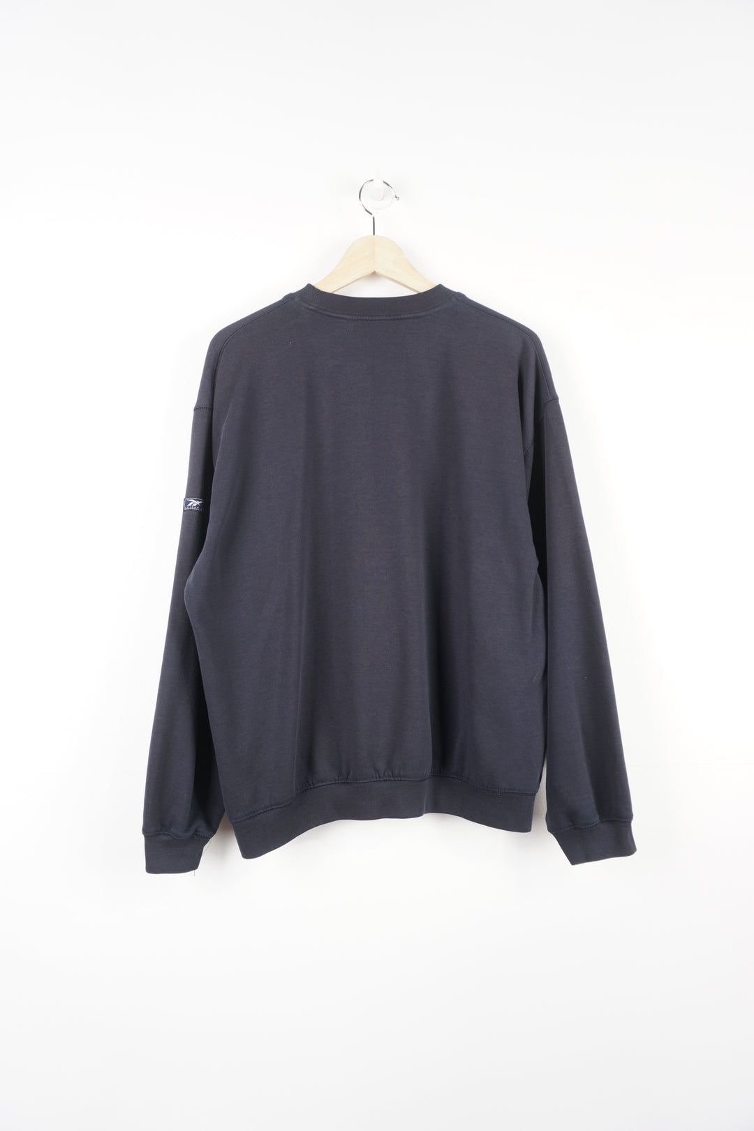 Navy blue Reebok sweatshirt features embroidered spell-out logo across the chest