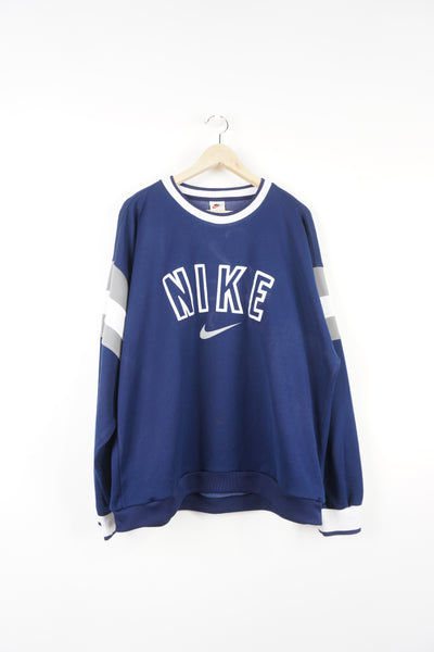 90s Nike navy blue sweatshirt features embroidered spell-out details across the chest