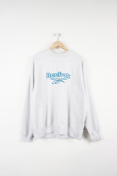 Reebok light grey sweatshirt features embroidered spell-out logo across the chest