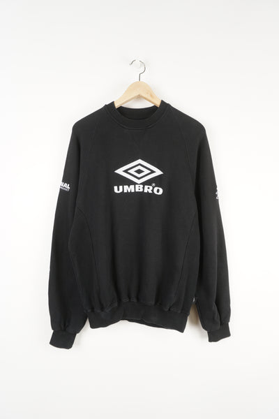 Umbro Pro Training black crewneck sweatshirt features embroidered logo across the front and on the sleeves