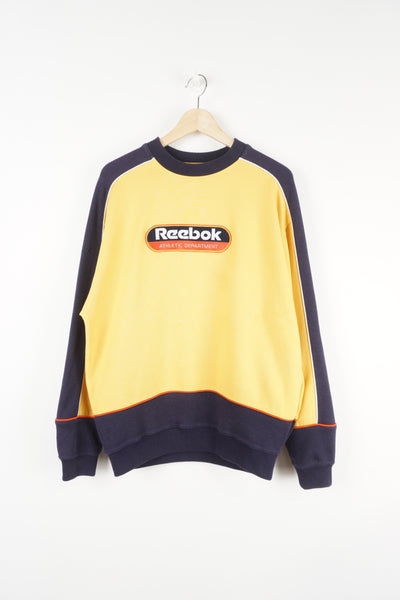 Reebok Athletic Department yellow and blue crewneck sweatshirt with embroidered spell-out logo across the chest