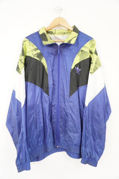 Purple and lime green 80's Adidas tracksuit top. Features embroidered spellout on the chest and full zip. 