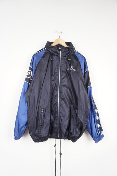 Vintage late 80's early 90's navy blue zip through Kappa track jacket, features  embroidered logo on the chest, branded ribbon on the sleeves and foldaway hood