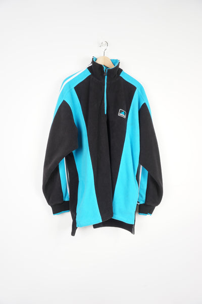 Vintage 90s Adidas 1/4 zip fleece features embroidered logo the chest and signature three stripe details down the sleeve