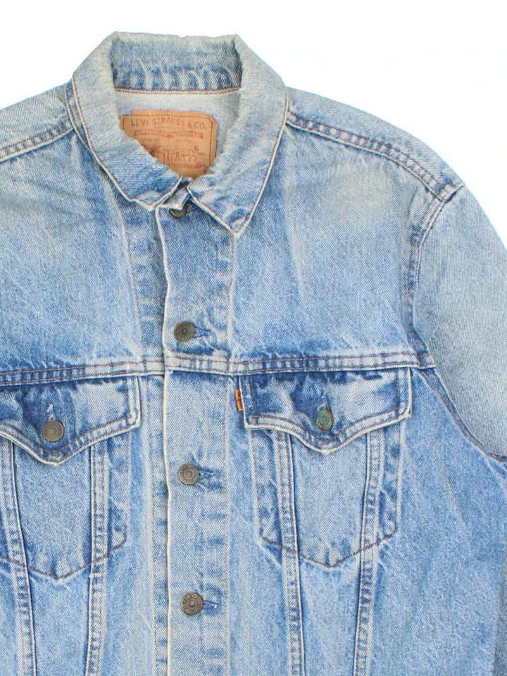 Vintage Levi Strauss Orange Tab Denim Jacket in a blue colourway. Buttons up and has double chest pockets, and the logo tab embroidered on the front.