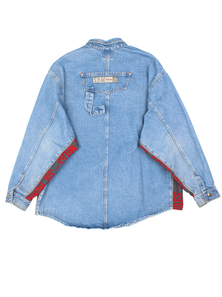 Vintage Sir Benni Miles Denim Jacket in a blue colourway with red detailing. Buttons up and has multiple pockets, and the logo embroidered on the front and back.