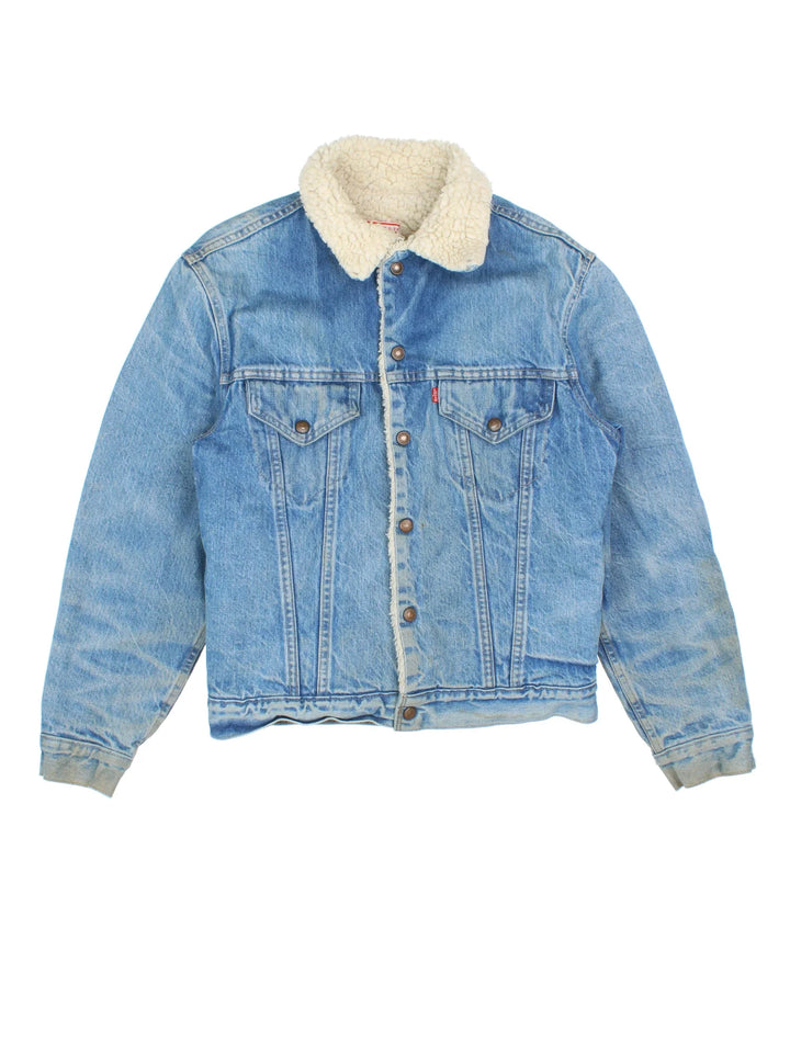 Vintage Levi Strauss Denim Sherpa Jacket in a blue colourway. Buttons up and has multiple pockets, insulated with a sherpa lining, and the logo embroidered on the front.
