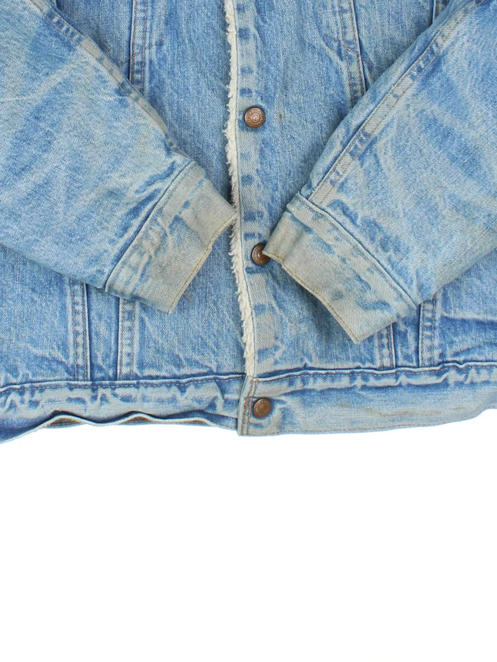 Vintage Levi Strauss Denim Sherpa Jacket in a blue colourway. Buttons up and has multiple pockets, insulated with a sherpa lining, and the logo embroidered on the front.