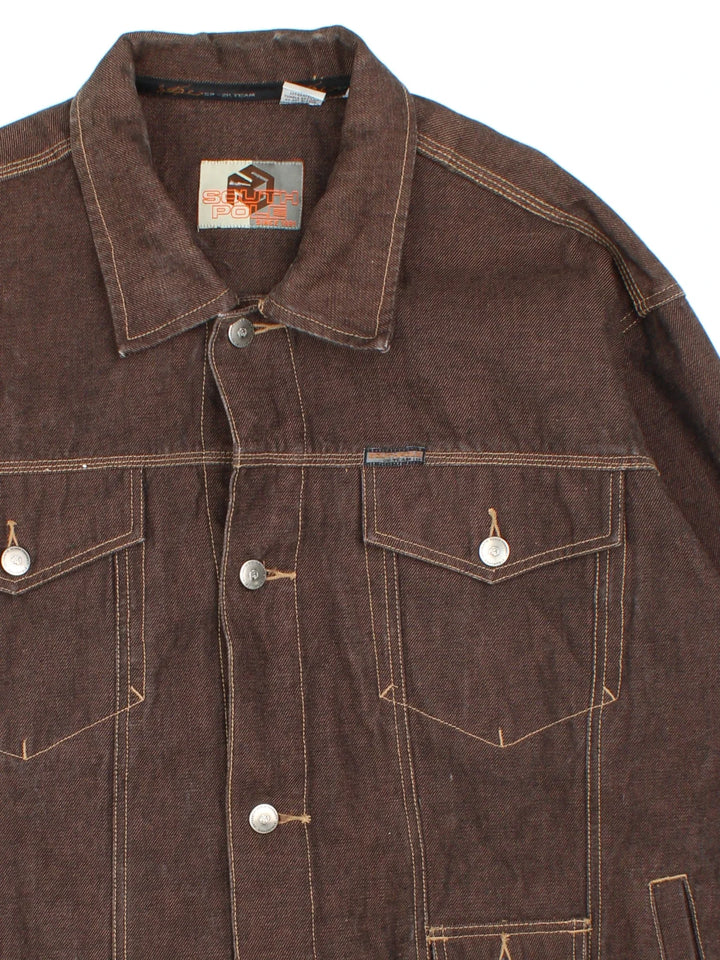 Y2K South Pole Denim Jacket in a brown colourway. Buttons up and has multiple pockets, and the logo tab embroidered on the front and back.