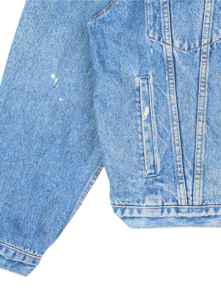 Vintage Levi Strauss Denim Jacket in a blue colourway. Buttons up and has multiple pockets, and has the logo embroidered on the front.