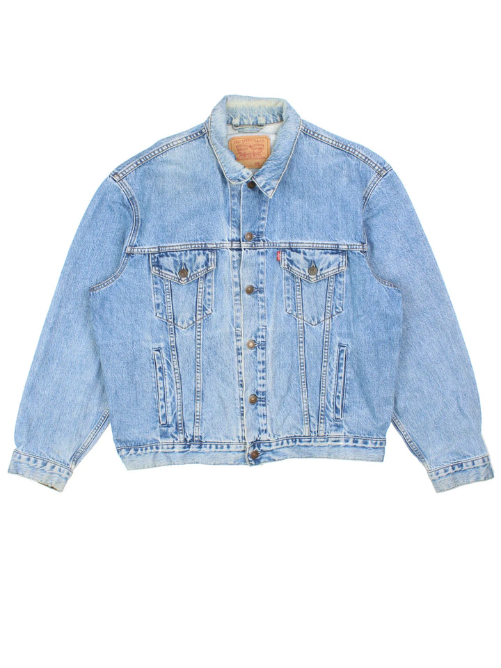 Vintage Levi Strauss Denim Jacket in a blue colourway. Buttons up and has multiple pockets, and has the logo embroidered on the front.