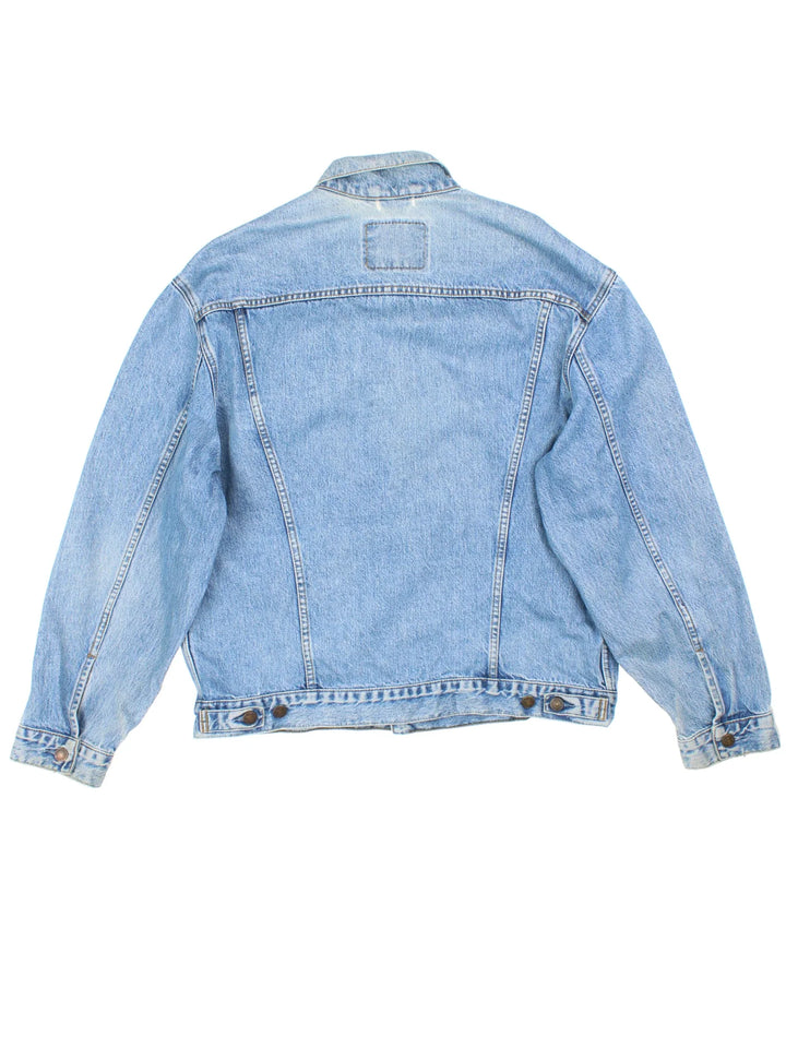Vintage Levi Strauss Denim Jacket in a blue colourway. Buttons up and has multiple pockets, and has the logo embroidered on the front.