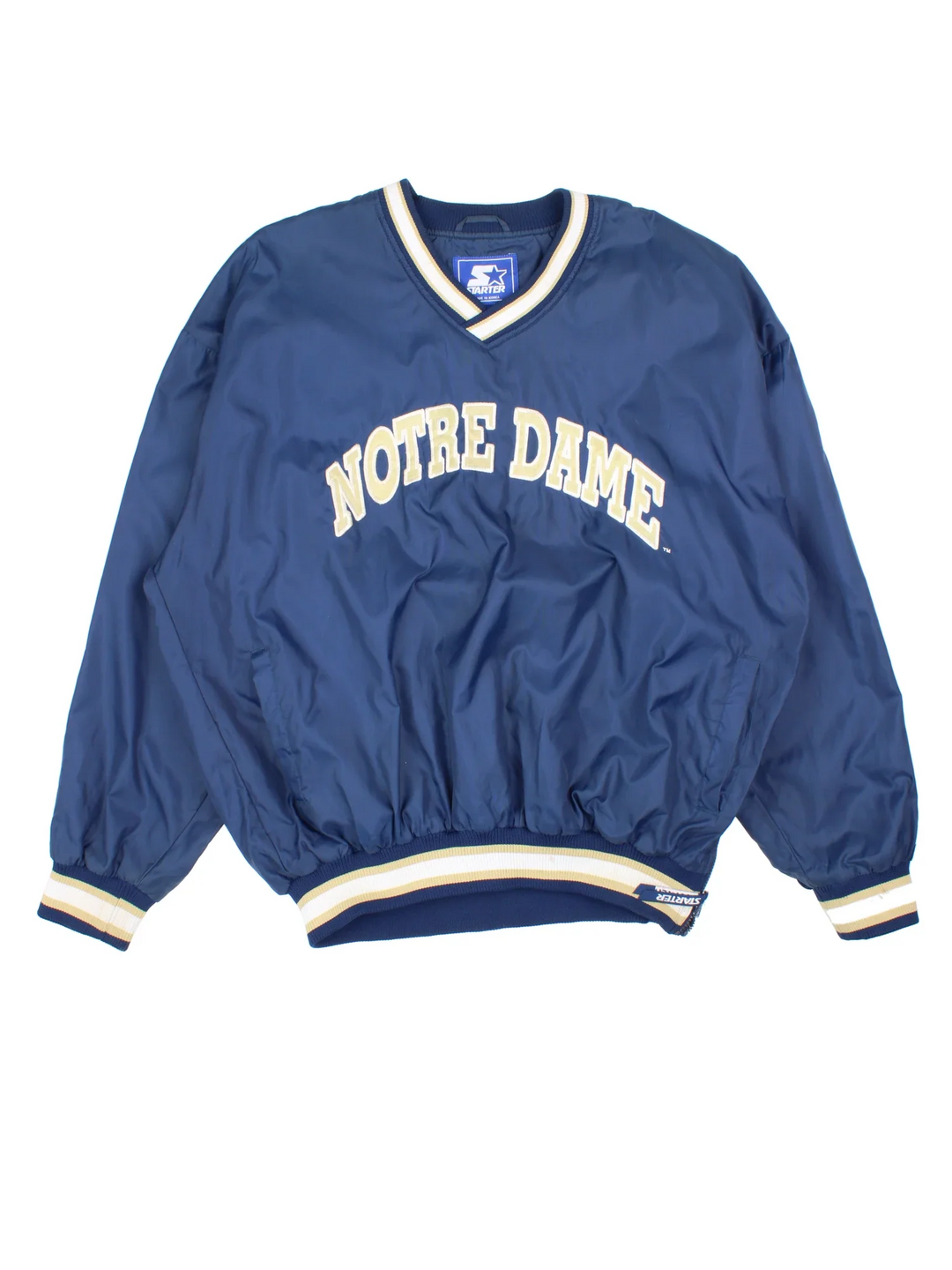 Vintage Starter Notre Damn Drill Training Top in a blue colourway. V neck, side pockets, contast piping and the logo embroidered on the front/back and sleeve.