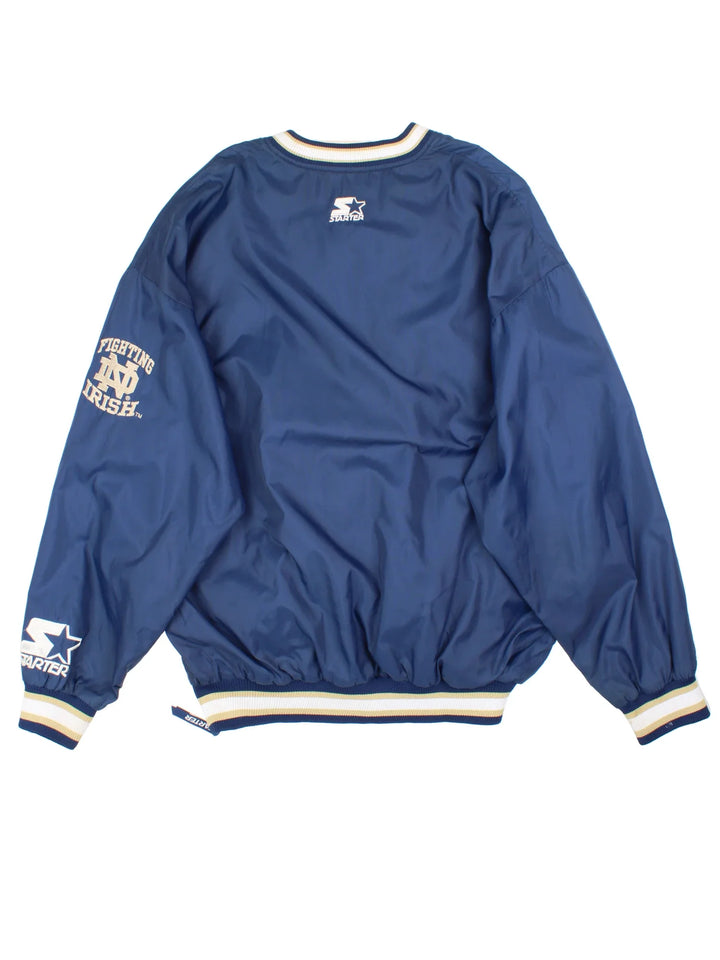 Vintage Starter Notre Damn Drill Training Top in a blue colourway. V neck, side pockets, contast piping and the logo embroidered on the front/back and sleeve.