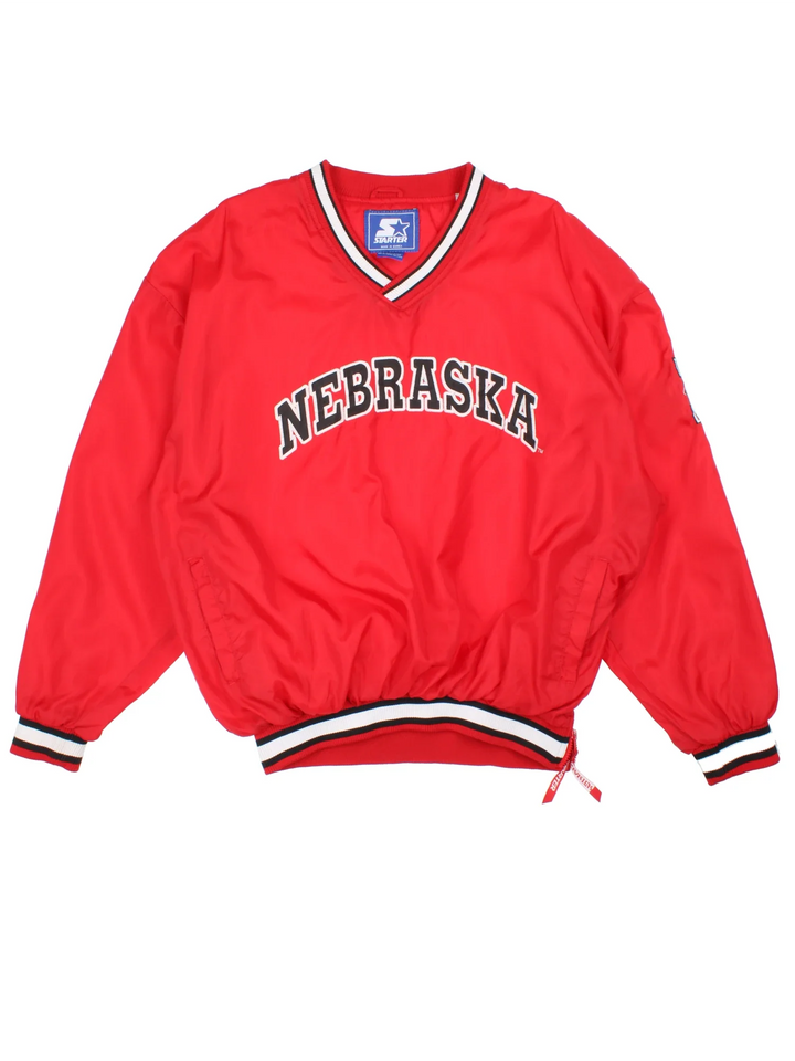 Starter Nebraska Drill Top in the red colourway. Features contrast cuffs/hems, side pockets and logos embroidered on the front/back/sleeve.